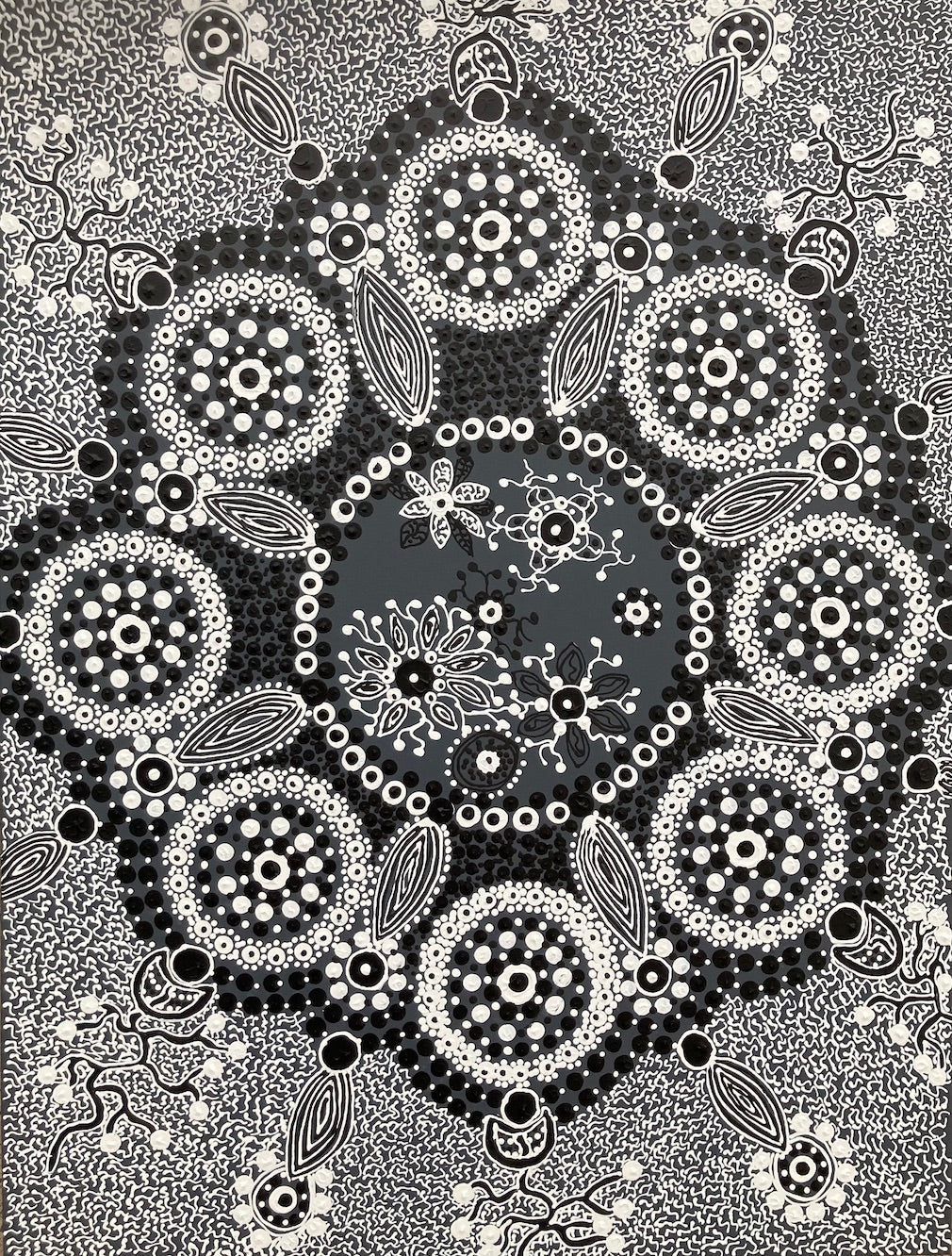 Mandala representation incorporation Aboriginal symbols and design in black and white dot art .